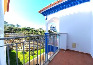 a balcony of a house with a view of the ocean at Beach House Espartal - Monte Clerigo - Aljezur in Vales