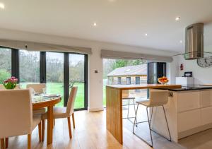 a kitchen and dining room with a table and chairs at Haons in Biddenden