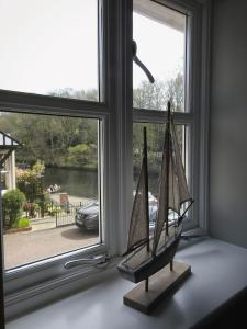 a model boat sitting on a window sill at The River House Knaresborough in Knaresborough