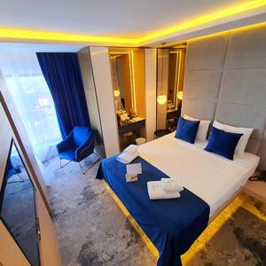 Un pat sau paturi într-o cameră la STEAUA DE MARE - Olimp Resort