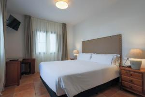 Postel nebo postele na pokoji v ubytování Hotel Tugasa Sierra y Cal