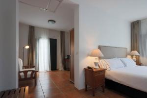 Postel nebo postele na pokoji v ubytování Hotel Tugasa Sierra y Cal