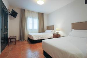 Postel nebo postele na pokoji v ubytování Hotel Tugasa Sierra y Cal