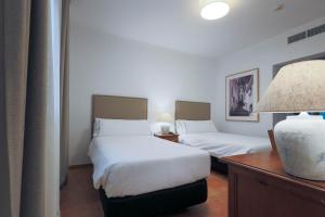 Postel nebo postele na pokoji v ubytování Hotel Tugasa Sierra y Cal
