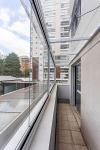 an empty balcony of a building with large windows at Igloo Vila Olímpia in Sao Paulo