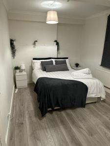 a white bedroom with a large bed in it at Spacious 4 bedroom house in the city of London in London