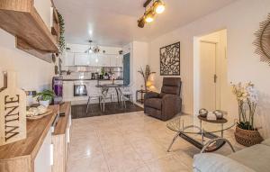 a living room and kitchen with a couch and a table at Urb, La Siesta in Torrevieja