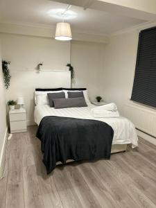 a white bedroom with a large bed in it at Spacious 4 bedroom house in the city of London in London