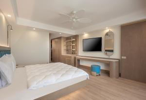a bedroom with a bed and a tv on a wall at Star Boutique Hotel in Antalya