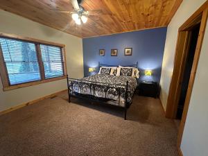 a bedroom with a bed and a ceiling fan at Donovans Dacha in McHenry