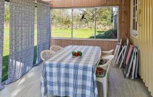a table with a blue and white table cloth on a porch at 2 Bedroom Stunning Home In Borgholm in Föra