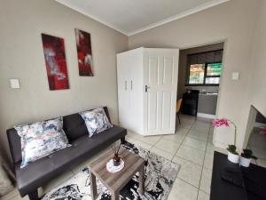 a living room with a couch and a table at Botle Hive in Kempton Park