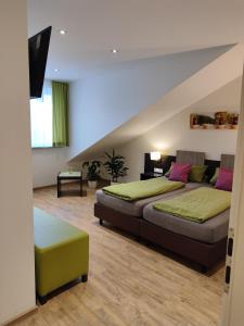 a bedroom with two beds and a staircase at Hotel Stock Teekännle in Friedrichshafen