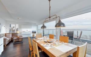 a dining room and living room with a table and chairs at Stunning Apartment In Eckernförde in Eckernförde