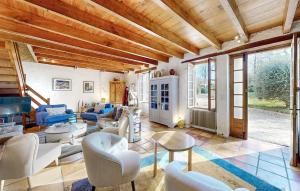 a living room with white furniture and a wooden ceiling at Nice Home In Monsegur in Saint-Ferme