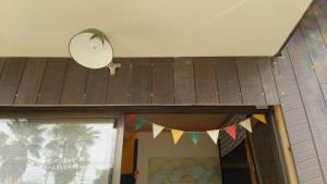 a building with a roof with flags on it at Guesthouse MI CASA SU CASA in Zentsuji