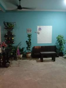 a living room with a couch and a christmas tree at D GARDEN HOME STAY in Tanah Merah