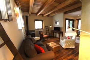ein Wohnzimmer mit einem Sofa und einem Tisch in der Unterkunft Baita Gran Bosco: appartamento per 6 persone in Monfol