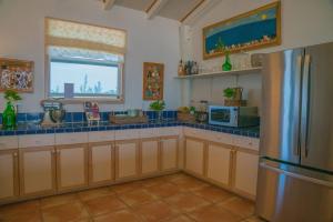 a kitchen with a refrigerator and a window at Villa Blue Hole in Mangrove Cay +63 photos