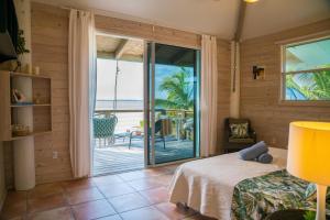 a bedroom with a bed and a view of the ocean at Villa Blue Hole in Mangrove Cay