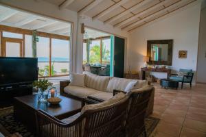 a living room with a couch and a table at Villa Blue Hole in Mangrove Cay