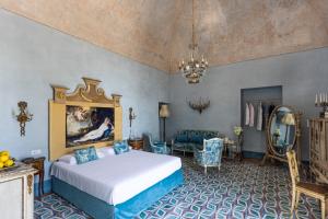a bedroom with a king sized bed in a room at Villa De Cillis Carafa in Torre del Greco