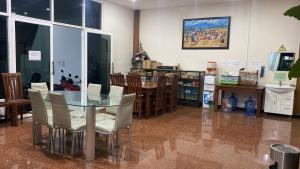 a dining room with a glass table and chairs at Bima guest house in Ngadipuro