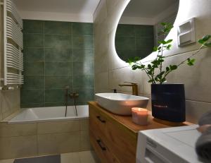a bathroom with a sink and a tub and a mirror at SuperApart Prymasa 1000-lecia 6a, Hidden Gem - Ideal for Relaxation & Escapes in Rzeszów +36 photos