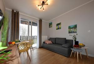 a living room with a couch and a table at SuperApart Prymasa 1000-lecia 6a, Hidden Gem - Ideal for Relaxation & Escapes in Rzeszów