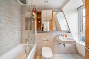 a bathroom with a shower toilet and a sink at Marble Arch Penthouse 2 Bed in London