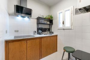 a kitchen with a sink and a tv on the wall at Panzani 13 in Florence