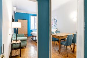 a dining room with blue walls and a table and chairs at Panzani 13 in Florence