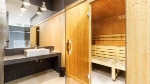 a bathroom with a sink and a sauna at Comfy Apartments - Morska Bryza in Gdańsk