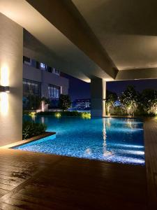 a swimming pool in a building at night at Homestay in Cheras