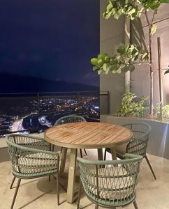 a table and chairs with a view of a city at Homestay in Cheras