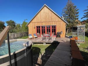 a backyard with a pool and a house at traumHaff Lotsen Romantik-Ostsee mit Kamin, privates NORDICSPA und Boot in Rieth