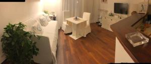 a living room with a white couch and a wooden floor at Ca Bea in Alassio