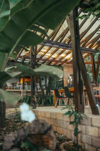 a patio with tables and chairs and a wooden ceiling at Casa Antônia - Pousada Boutique in Lençóis