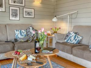 a living room with a couch and a table at traumHaff Lotsen Romantik-Ostsee mit Kamin, privates NORDICSPA und Boot in Rieth