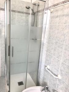 ducha con puerta de cristal junto a un aseo en Casa Marri, en Camogli