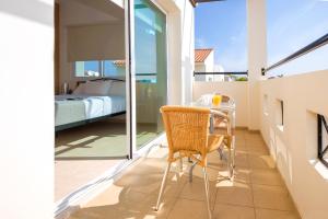 a room with a table and a bed on a balcony at Villa Ivy in Protaras