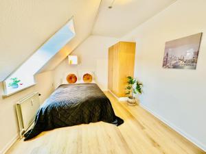 a bedroom with a bed in a attic at aday - Stylish Central Apartment in Hjorring in Hjørring