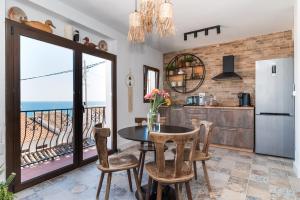 a kitchen with a table and a view of the ocean at The Dreamer Balcón con Vistas al Mar by Vero in Altea