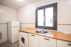a kitchen with a sink and a window at Recogidas Apartment 23 in Granada +32 photos