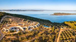 una vista aérea de un edificio en una colina junto a un lago en Villa Nai 3.3, en Žman