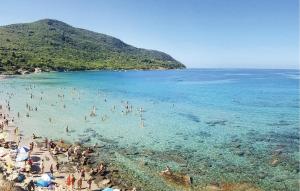 a group of people in the water at a beach at Cozy Apartment In Ogliastro Marina in Montecorice