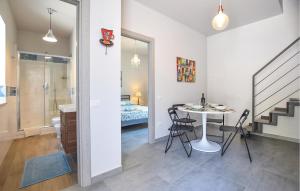 a room with a table and chairs and a bedroom at Cozy Apartment In Ogliastro Marina in Montecorice