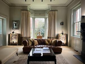 a living room with a couch and a table at Blythe House - Emsworth in Emsworth