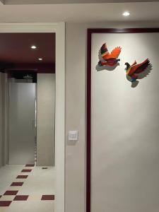 a hallway with two bird decals on the wall at Living Yard Thissio in Athens