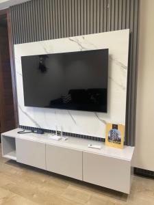 a large entertainment center with a large television on a wall at Solaris Premium Luxury Living in Accra